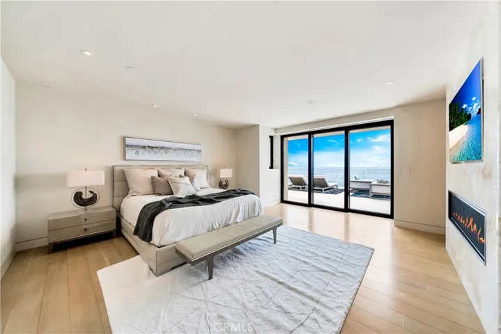 Primary suite with patio doors, built ins, tv & fireplace