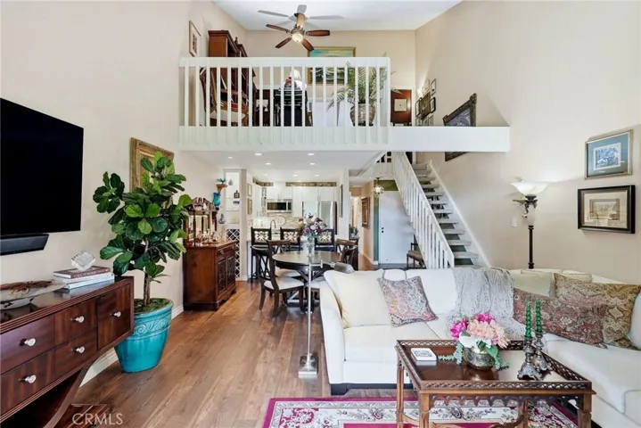 Full view of living area on main floor with loft and 2nd bedroom on the upper floor.