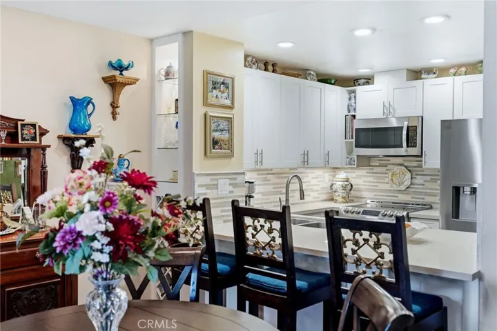 Remodeled kitchen with breakfast bar, new cabinetry and SS appliances.