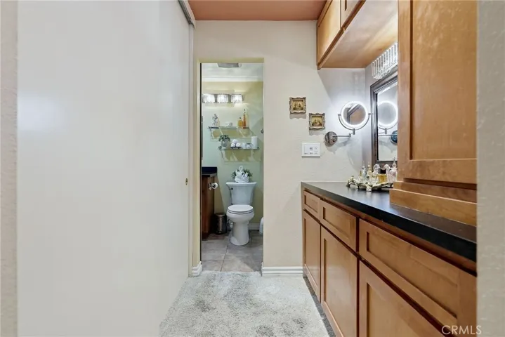 Looking towards bathroom from the main floor bedroom, enjoy a 2nd vanity and more storage space. Closet iOS on the left.