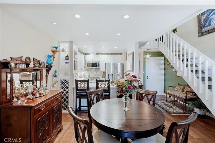 Dining area with kitchen and stairs leading to the loft and 2nd​​‌​​​​‌​​‌‌​​‌​​​‌‌​​​‌​​‌‌​​‌‌​​‌‌​​​​ bedroom.