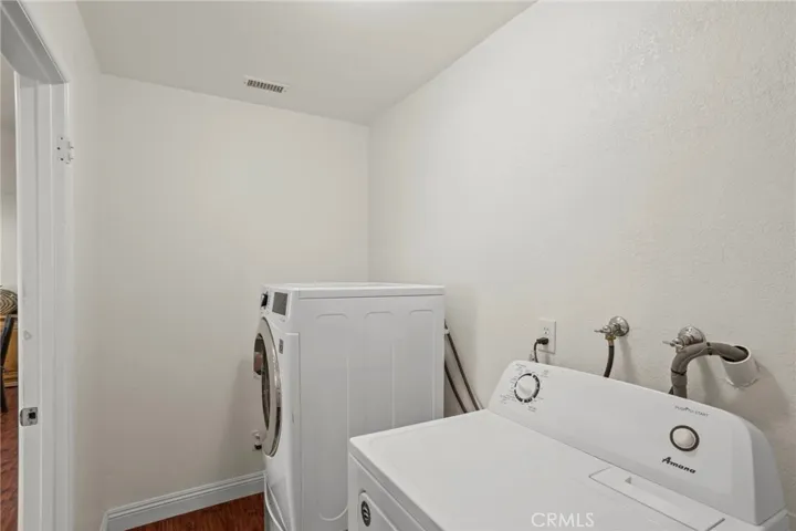 Dedicated indoor laundry room with additional storage potential