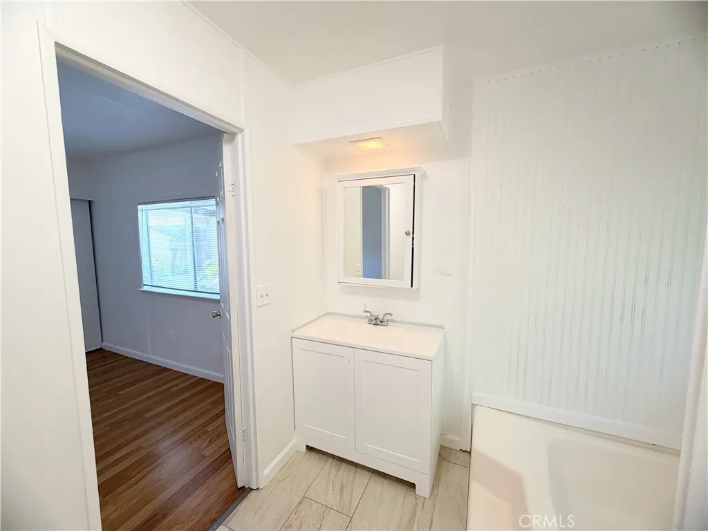Primary Bathroom with newer vanity & tile flooring.