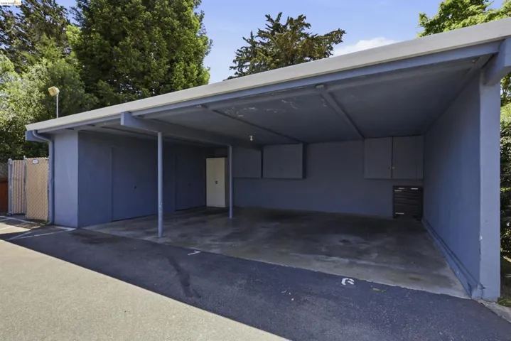 Covered parking structure with concrete flooring and a flat roofline