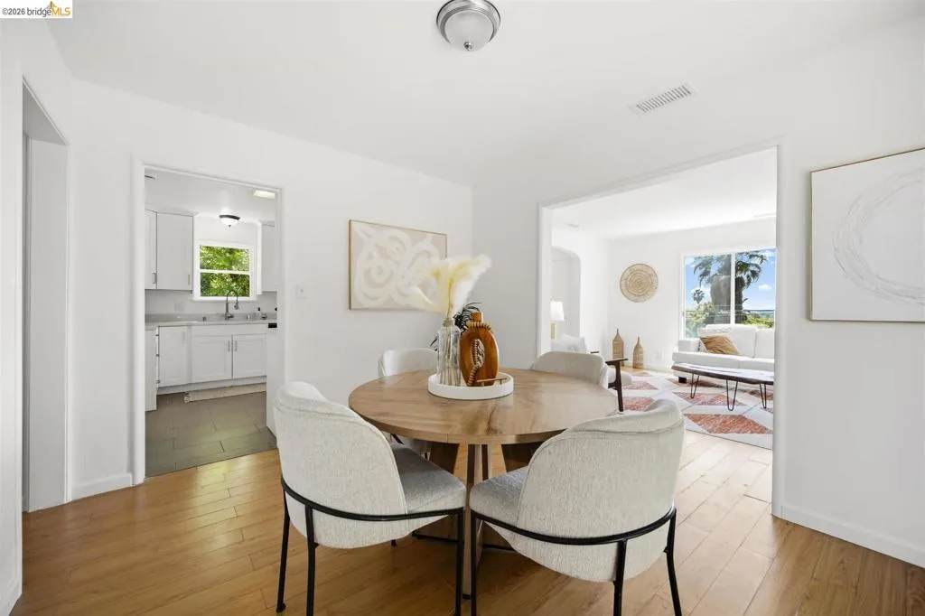 Light wood-finish flooring throughout, complemented by crisp white walls and white baseboards
