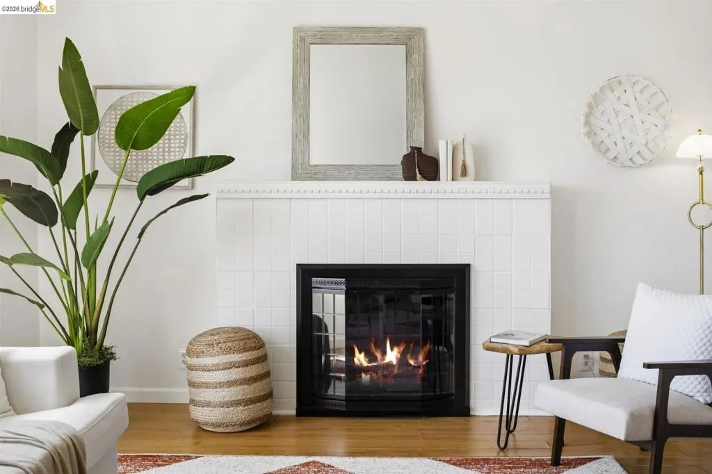 Fireplace featuring a white tiled surround and a black firebox