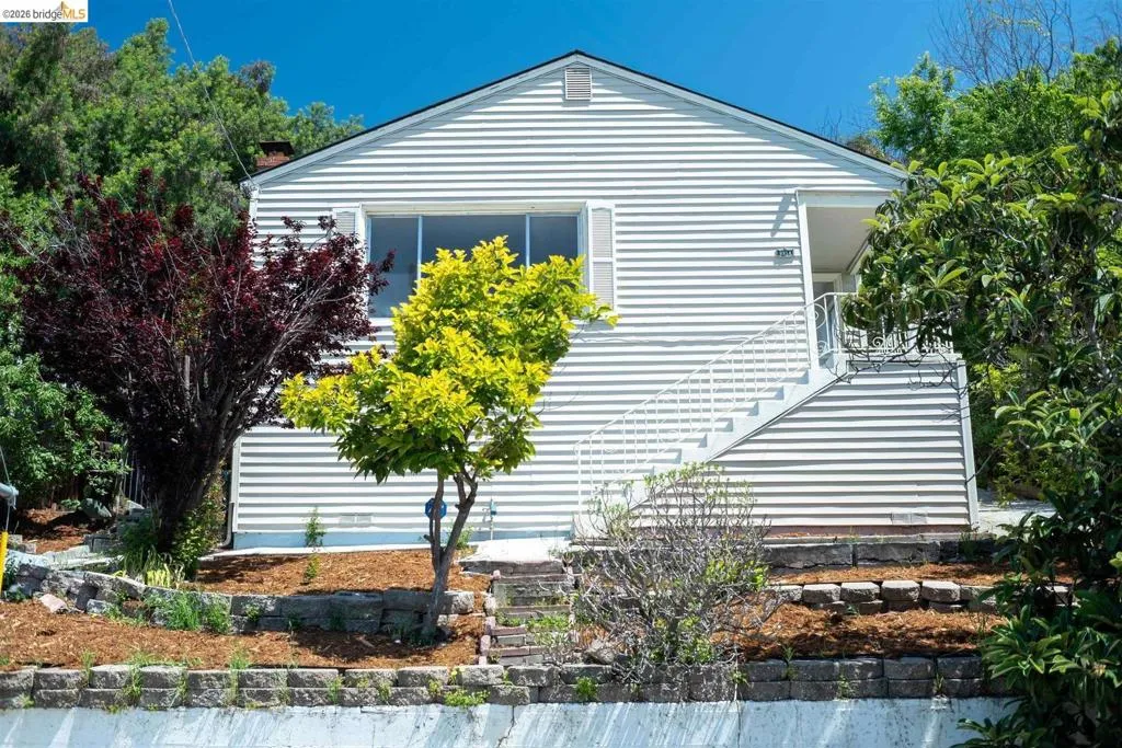 White horizontal siding exterior with a pitched roofline
