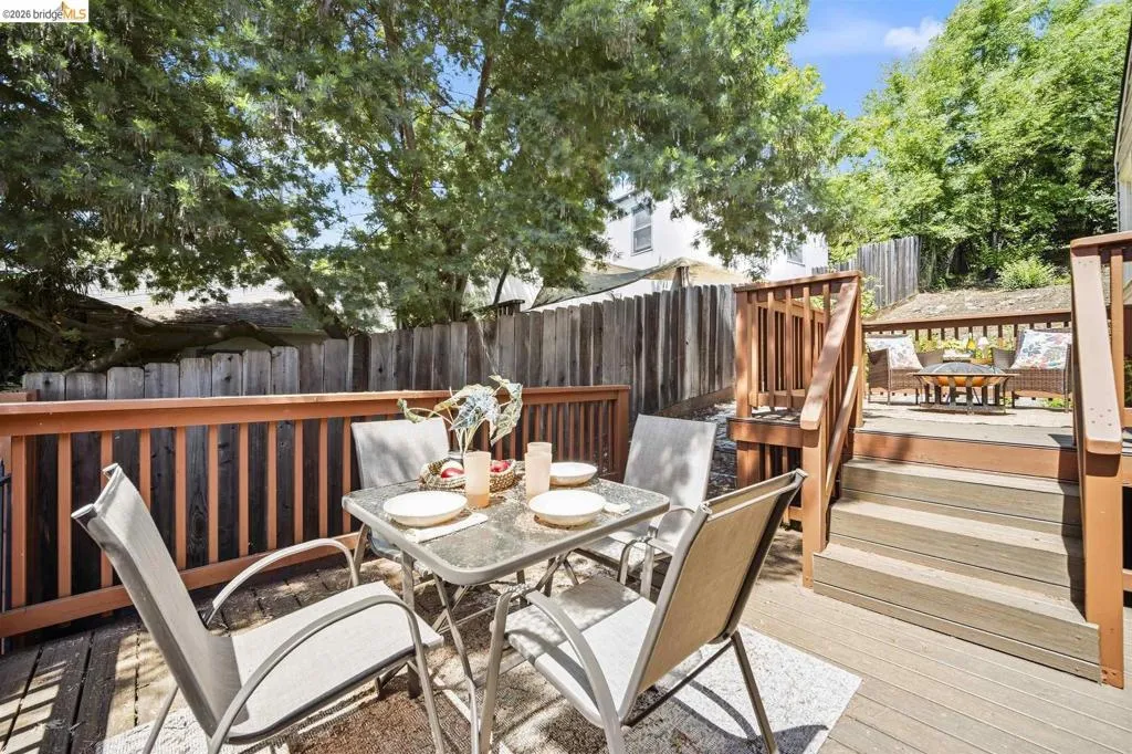 Multi-level wood deck featuring a dining area, integrated stairs, and a separate seating platform