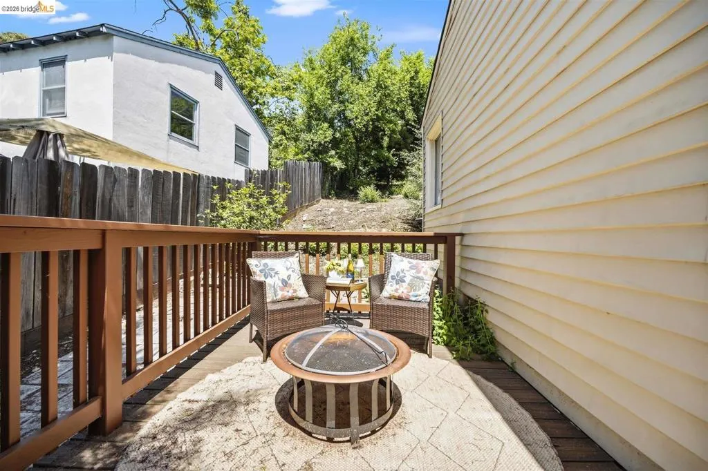 Private deck area featuring wood decking, wood railing, and horizontal siding