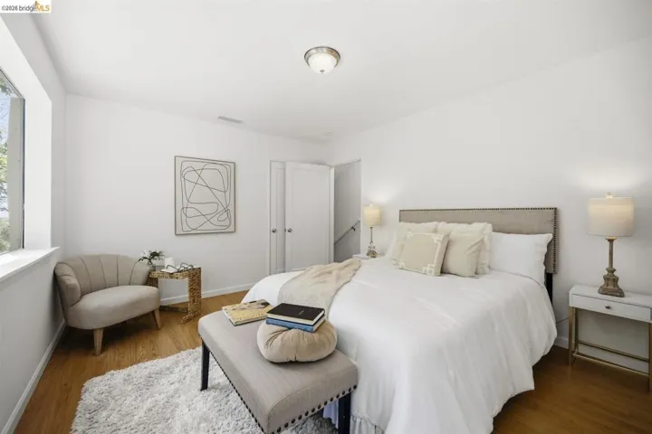 Light-filled room featuring wood-finish flooring and a window with white trim
