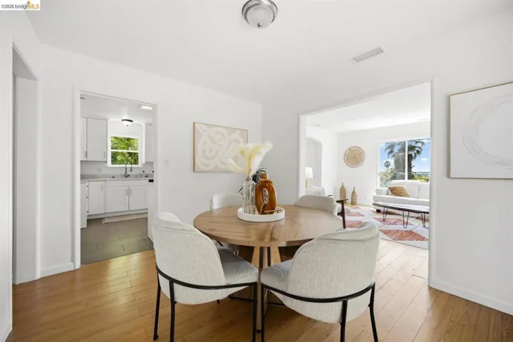 Light wood-finish flooring throughout, complemented by crisp white walls and white baseboards