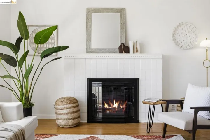 Fireplace featuring a white tiled surround and a black firebox