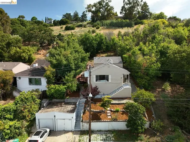 Single-story residence featuring a neutral exterior, a covered porch, and exterior staircase access