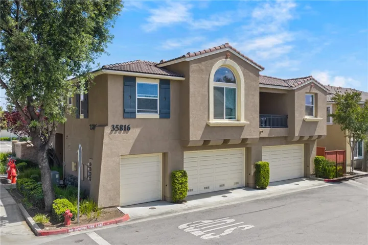 Enjoy the privacy of a corner unit condo that lives like a townhome.