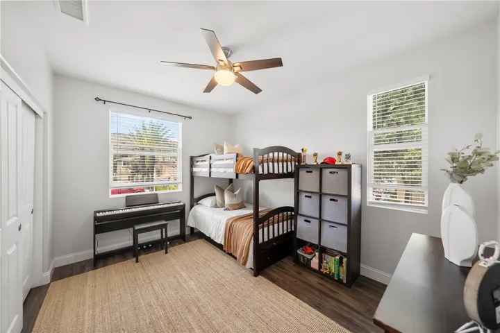 Secondary Bedroom with great natural lighting, upgraded luxury vinyl plank flooring, and a large closet.