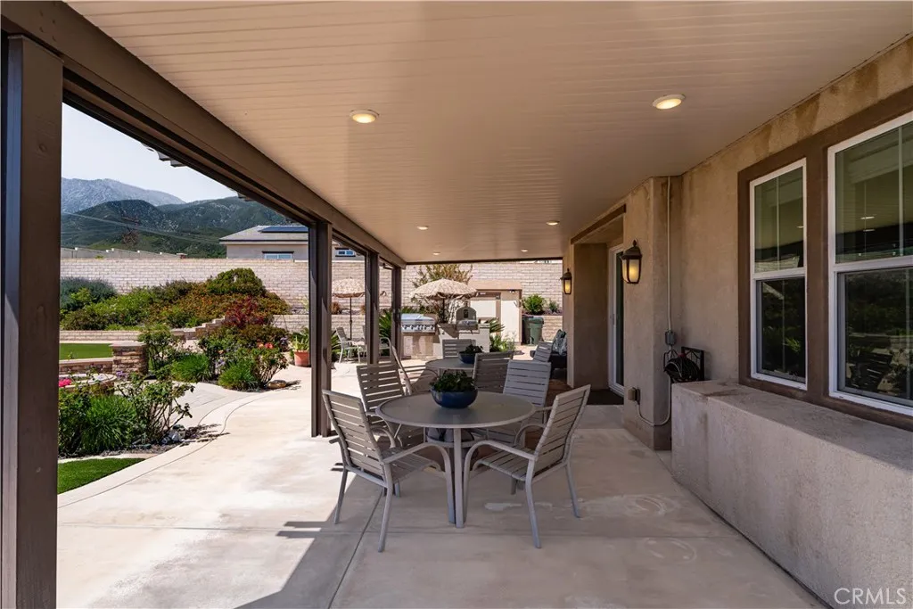 Large covered alumiwood patio cover with recessed lighting and automating drop down shades