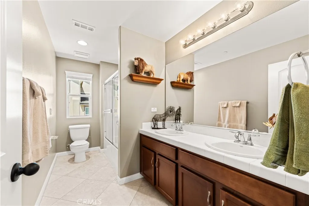 Upstairs shared full bathroom with shower tub combo