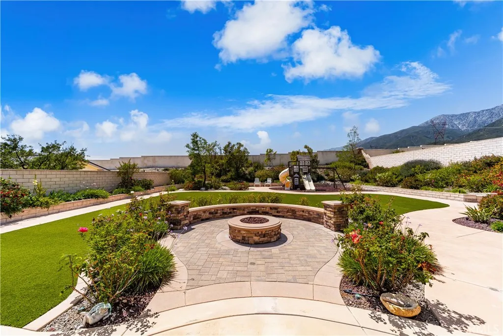 Gas fire pit with plenty of seating is the heart of this backyard