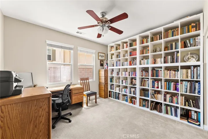 Downstairs bedroom with lighted ceiling fan