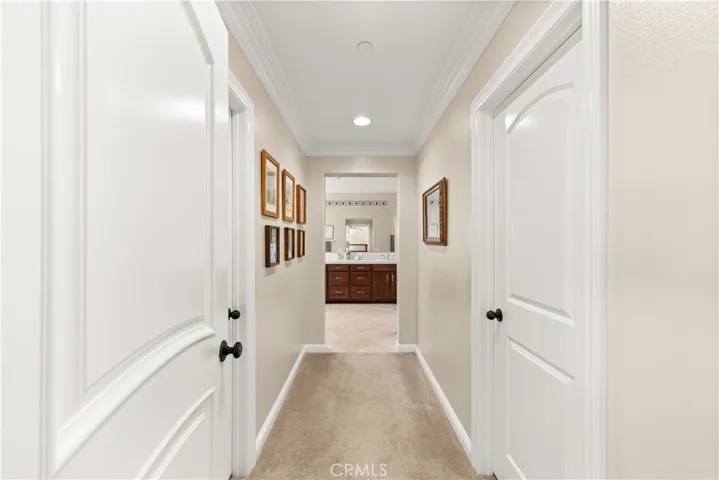 His and her closets in the primary with plush carpet