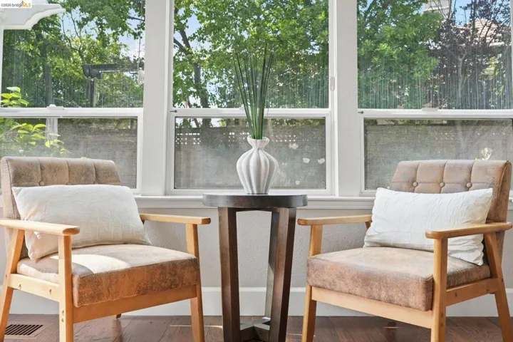 Bright interior featuring multiple sash windows, dark wood-finish flooring, and white wall finishes
