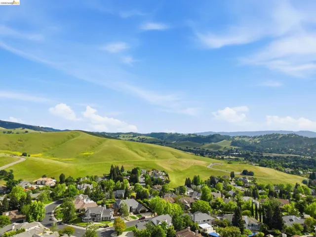Residential community featuring a variety of architectural styles, mature trees, and a winding road network