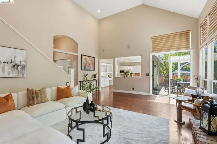 Vaulted ceilings enhance the main living area with wood-finish flooring
