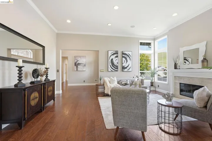 Spacious living area featuring wood-finish flooring and recessed lighting