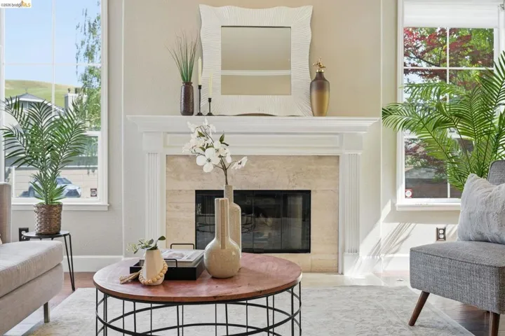 Fireplace with a stone surround and classic white mantel