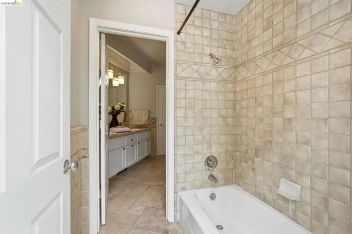 Full bathroom featuring a white porcelain bathtub with chrome fixtures