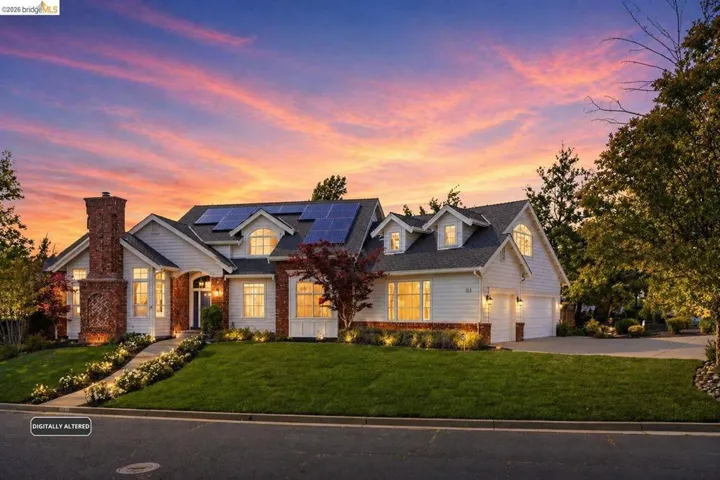 Exterior architecture featuring white siding, brick accents, and multiple gables