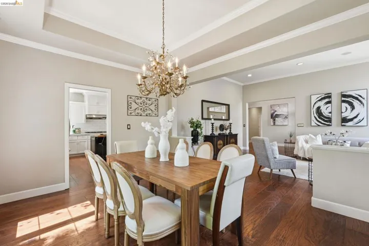 Open-concept interior featuring wood-finish flooring, coffered ceilings, and crown molding