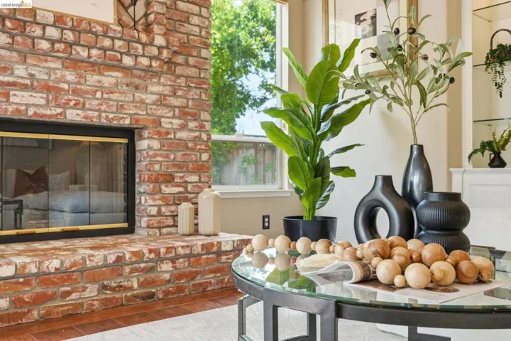 Brick fireplace with a glass enclosure and a substantial hearth