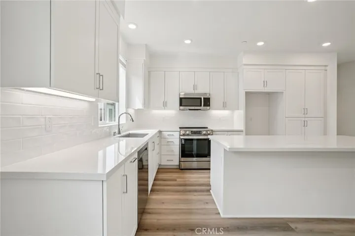 Kitchen with large island and all-electric appliances