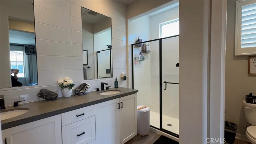 Primary Bathroom with dual vanity and walk in shower