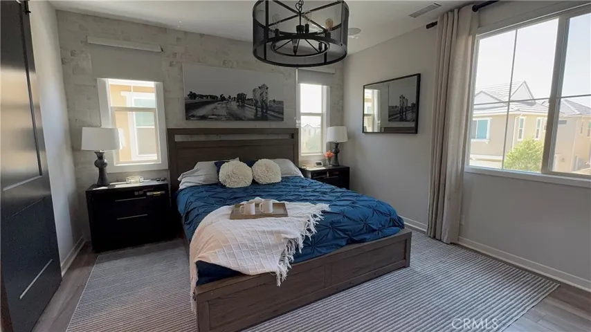Primary bedroom with edison light chandelier