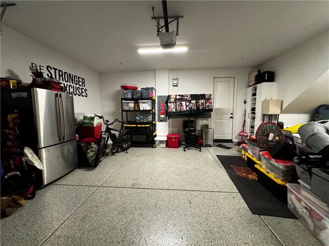 Spacious 2 car garage with epoxy flooring and custiome shelving