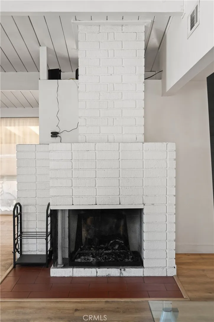 The living room enjoys this standalone fireplace.