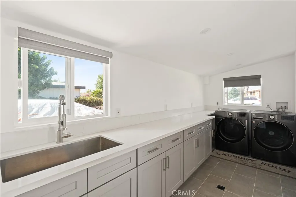 The room off the garage has a kitchen sink, tons cabinet space and laundry hook ups