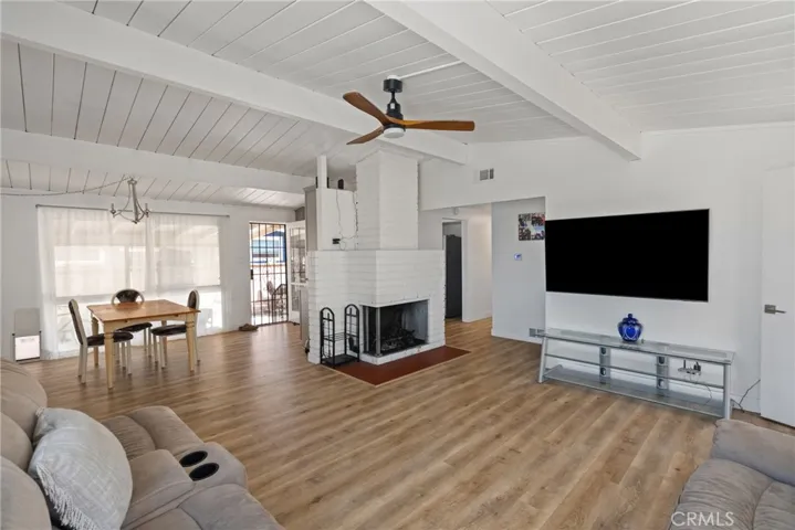 Open-concept living room with vaulted ceilings and luxury vinyl floors | Original Photo