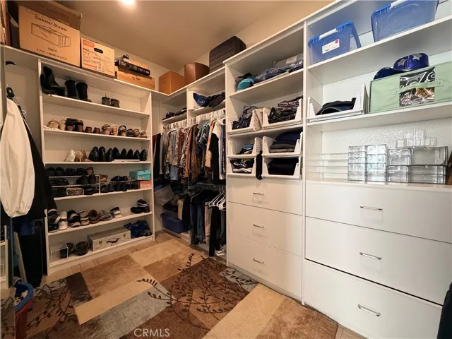 Walk-in closet in primary bedroom suite