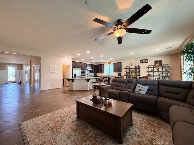Open floor plan with view from living room to front door on the left, kitchen in the center and dining room area on the right. Wide open spaces make everything very acccesible
