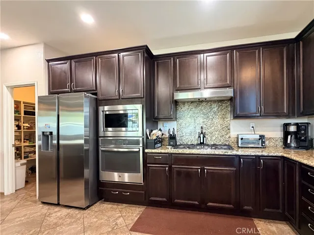 The working core of this kitchen is set up so efficiently, with just a couple steps between the walk-in pantry, fridge, oven, and cooktop