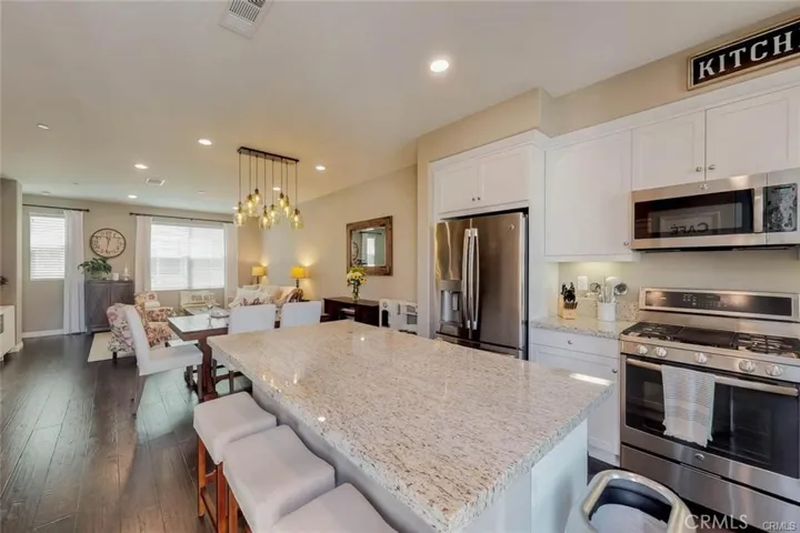 The built in Counter in the Kitchen for casual meals has great cabinetry underneath for storage along with a nice Food pantry and Laundry room with State of the Art Washer and Dryer which is included in the sale.
