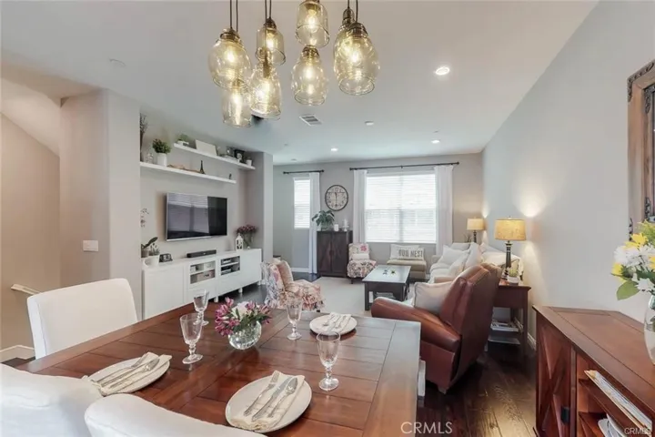 The Table is set for a bite to eat with Family and Friends.  This home has some custom furnishings and beautiful  Wood flooring on the first and second floor and one staircase from the 1st to the second floor has wood stair steps. .  The home has 4 total Bathrooms and 1 is 1/2 bath.  Enjoy the Dining Room Chandelier while Dining.