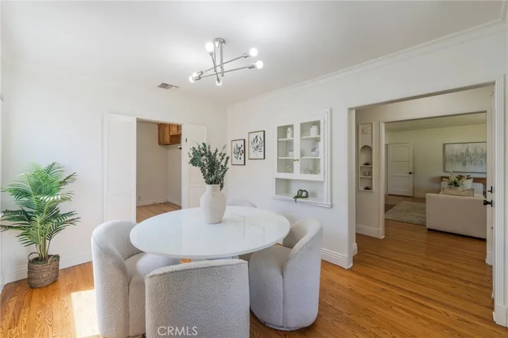 Formal dining room with multiple windows and access directly to the kitchen and living room.