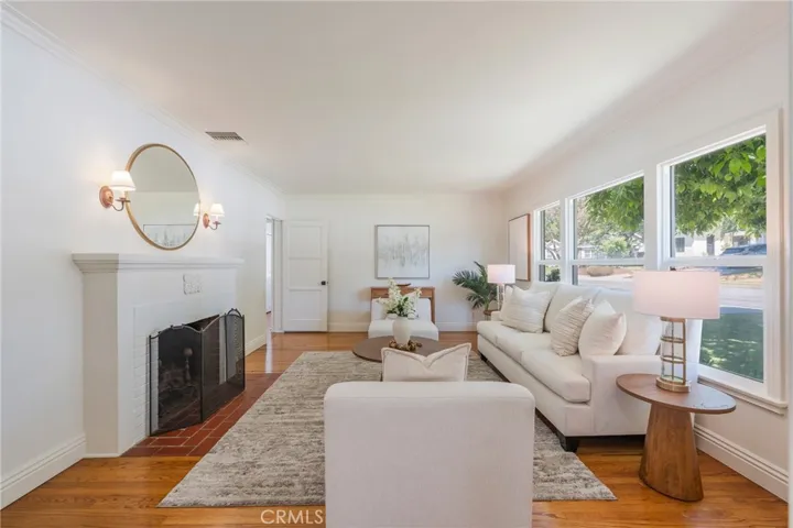 Formal living room with fireplace and large windows facing north.