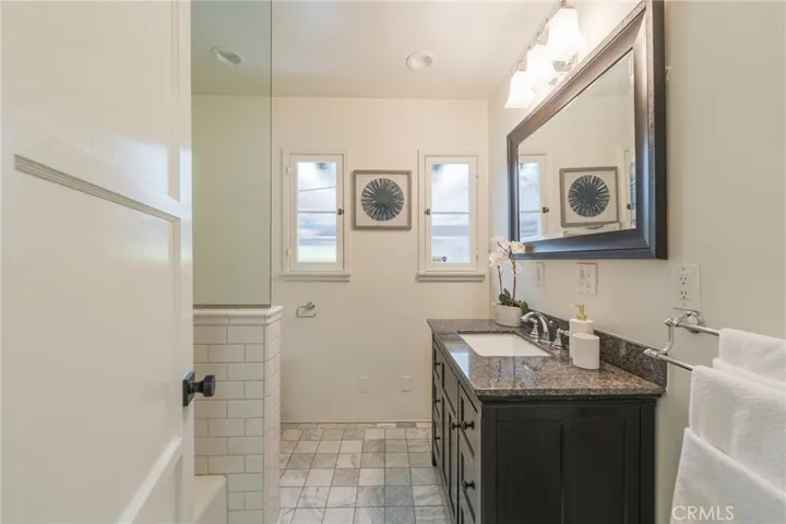 Updated full-sized bathroom with beautiful flooring.