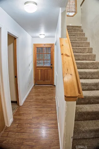 Stairwell with hall leading to Laundry and Bed Rooms