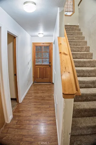 Stairwell with hall leading to Laundry and Bed Rooms